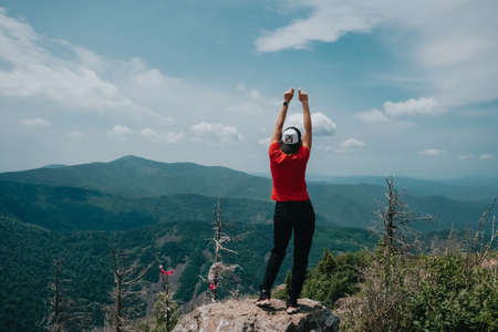 A girl on top of Falaza mountain looks at a beautiful mountain valley. Travel and tourism. Hikingの写真素材