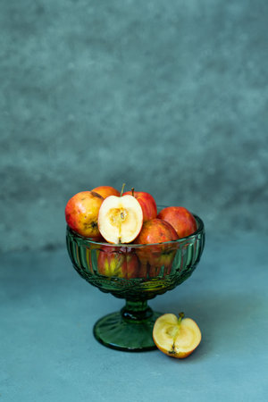 Fresh red apples in a glass vase on a gray background. high quality photoの写真素材