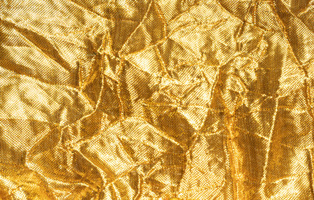 Gold background with fabric textureの写真素材