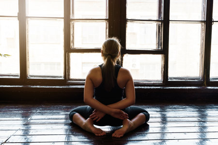 A young girl in sportswear does yoga, fitness at home, sports at home, stretchingの写真素材