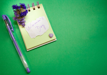 Planner with message for Womens Day . Green background . Space for copyingの写真素材
