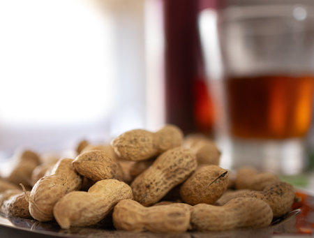 Peanuts in the foreground next to a summer snack on an out-of-focus backgroundの写真素材