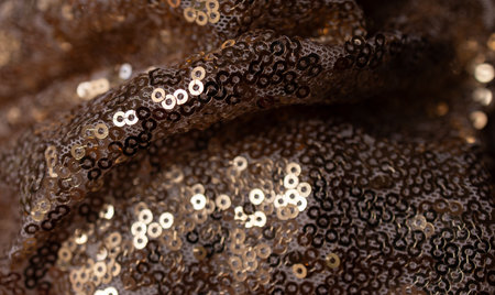 Horizontal shiny wavy shot texture for wallpaper.Gold sequined fabric. Abstract backgroundの写真素材
