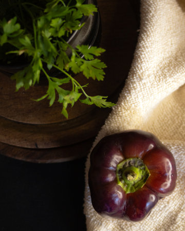 Purple pepper on a country rustic table decoreted with parsley