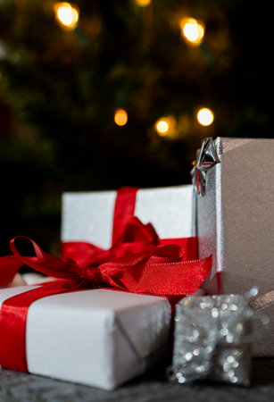 Vertical close-up of image .Gift boxes under Christmas tree. Christmas holiday concept. Real photo ....