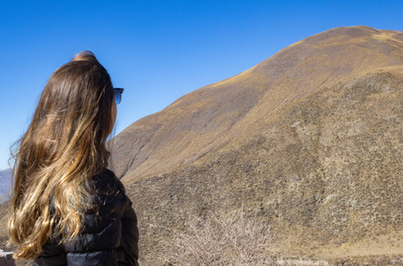 Woman enjoying nature. Background for tourism ads. Landscape of Salta. Copy space. Real picture