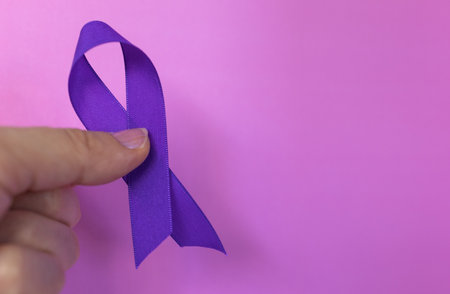 World Cancer Day symbol on a purple background.Cancer protection awareness. Copy space.Real picture. horizontal banner for medical magazinesの写真素材