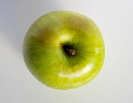 Freshly harvested fruit, fresh green apple on light background, Healthy food concept. Natural ingredient for juices and culinary preparations.の写真素材