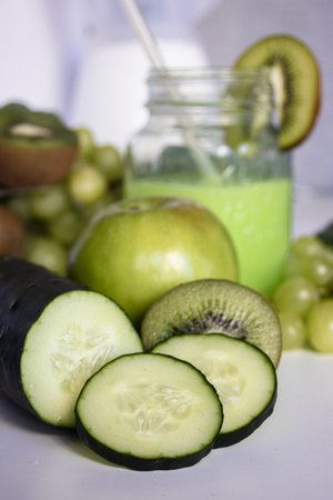 Glass jar with green smoothie. Freshly vegetarian food ingredients.Healthy food concept. Variety of organic fruits and vegetables. Vegan menu. Vertical real pictureの写真素材