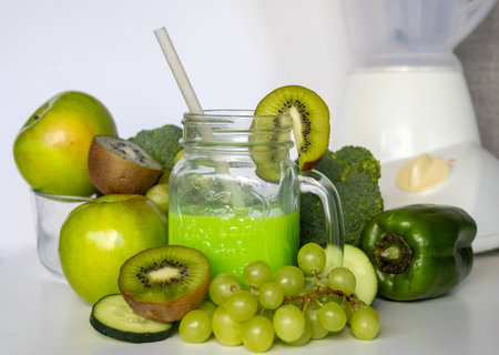 Glass jar with green smoothie,.Healthy vegetarian food ingredients.Healthy food concept. Variety of organic fruits and vegetables. Vegan menu. Space for text.の写真素材