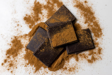 Tasty dark chocolate chunk sprinkled with cinamon or cocoa powder. Ideal for recipe visuals, artisanal branding, or rustic dessert promotions.A perfect choice for holiday recipe graphics, seasonal announcementsの写真素材