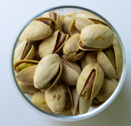 Macro photography of pistachios with special attention to texture and freshness. Ideal for healthy eating images.Minimalist composition with pistachios. Healthy lifestyle.の写真素材