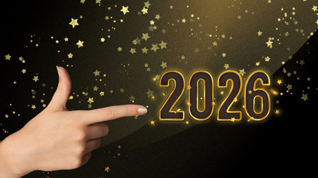 Festive golden 2026 numbers with sparkling decoration and female hand,perfect for banners, holiday...