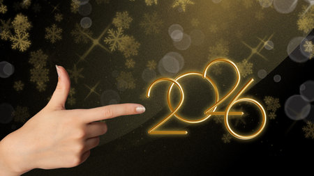 Bright golden 2026 with sparkling background and female hand, perfect for creative New Year design projects.Luxury golden background.の写真素材