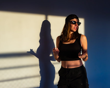 Blonde girl smiling and dancing in sunset glow, perfect for editorial, ads, and creative projects.の写真素材