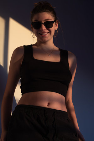 Teen woman expressing freedom and positivity under evening sunlight.