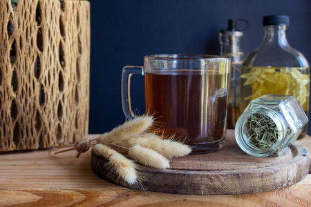 Warm herbal tea sits on a wooden board, featuring natural ingredients, and various botanical infusions, promoting wellness and holistic care. Copy spaceの写真素材