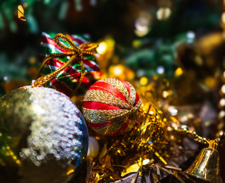 Festive decorations in red, gold and green, with glowing lights and blurred background,creating a cozy, festive holiday still-life scene. Ideal for greetings backdrop and digital projectsの写真素材