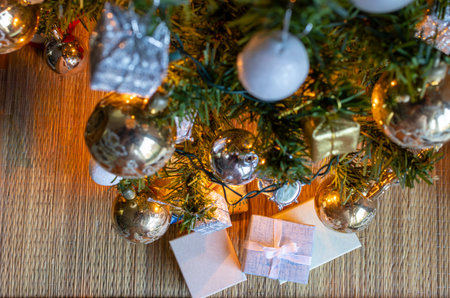 Horizontal shot from above of Christmas gift boxes shining with warm light .Seasonal...