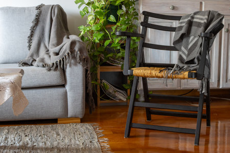 Cozy living room corner with rustic chair and plant. Natural light. Horizontal real pictureの写真素材