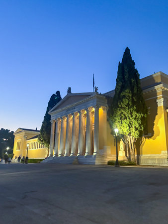 The neoclassical columns of the Zappeion Hall in Athens, Greece illuminated. This historical...