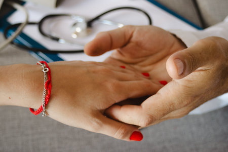 Doctor gently holding a patient's hand, conveying compassion, understanding, and reassurance during...