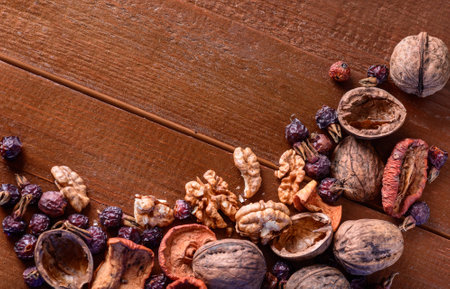 background from dried fruits, walnuts and dried berries rose hips on the wooden tableの写真素材