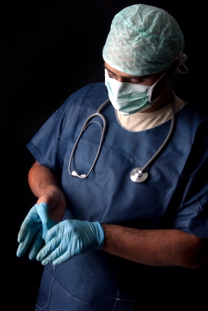 doctor getting ready for surgery on black backgroundの写真素材