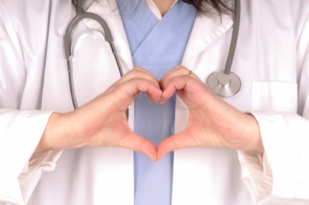 female doctor isolated in white doing heart shape with handsの写真素材
