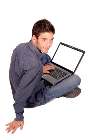 teenage boy with computer isolated in whiteの写真素材
