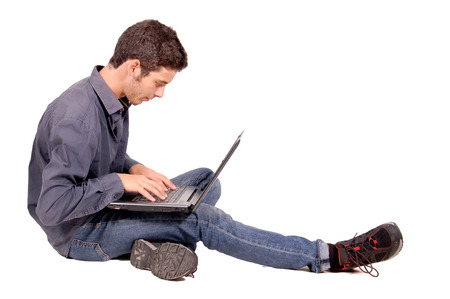 teenage boy with computer isolated in whiteの写真素材
