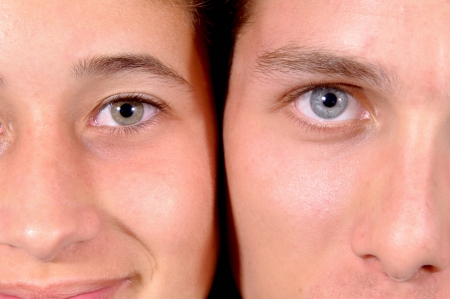 young man and girl with beautiful blue and green eyesの写真素材