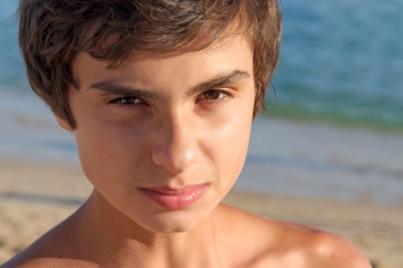 teenage boy posing on the beachの写真素材