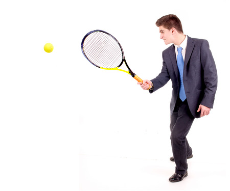 young businessman playing tennis isolated in whiteの写真素材