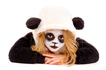 little girl painted as a panda bear isolated in whiteの写真素材