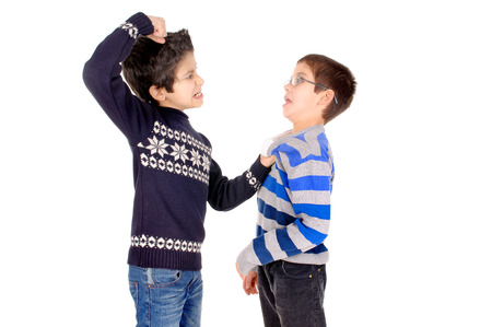 little boy bullying classmate isolated in whiteの写真素材