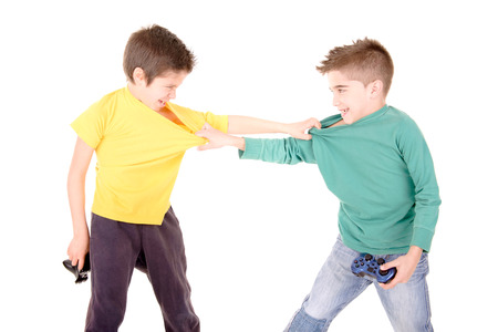 little boys playing videogames isolated in whiteの写真素材