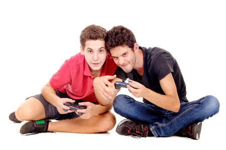 Teenage boys playing videogames isolated in whiteの写真素材