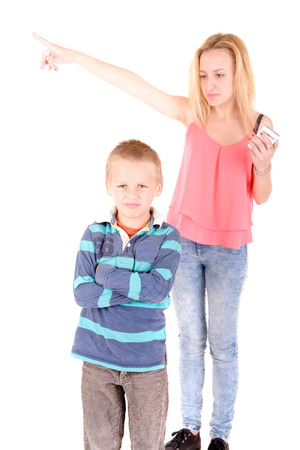 teenage girl mad at little brother isolated in white backgroundの写真素材