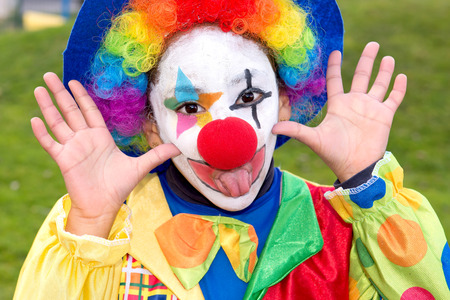 little girl dressed as a clown on halloween having fun togetherの写真素材