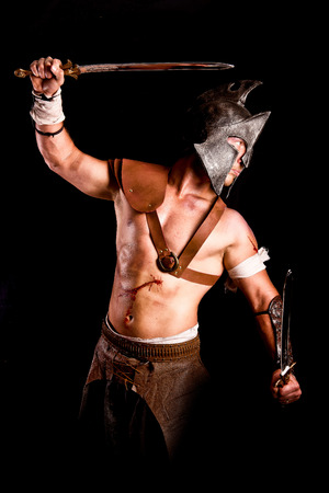 strong gladiator isolated in dark backgroundの写真素材