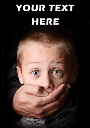 child being abducted over dark backgroundの写真素材