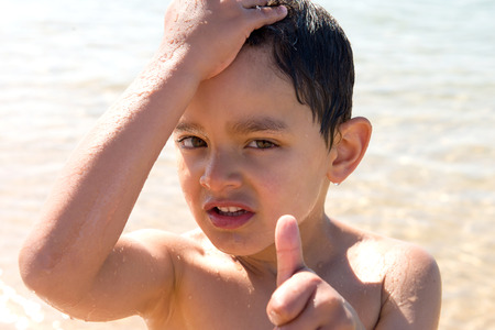 little boy posing at the beach