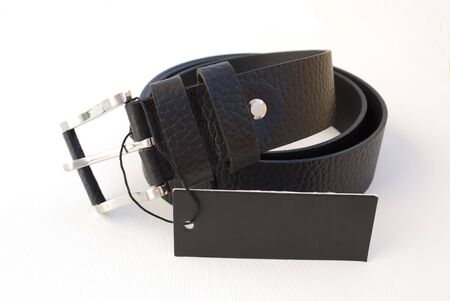 new black leather men's belt with a black backgroundの写真素材
