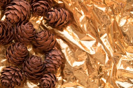 pine cone on a gold background. Postcard for autumn and new year. Golden colorの写真素材