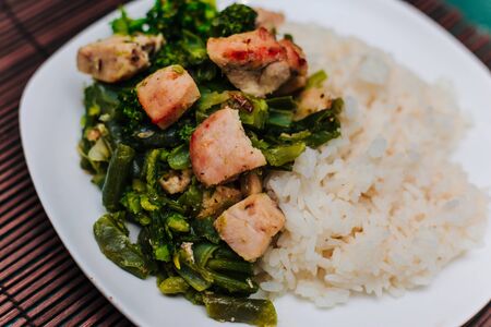 plate with broccoli and beans stewed vegetables with chicken.の写真素材