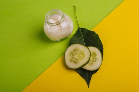 White cucumber cream on a yellow-green background.の写真素材
