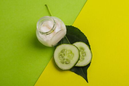 White cucumber cream on a yellow-green background.の写真素材