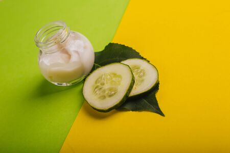 White cucumber cream on a yellow-green background.の写真素材