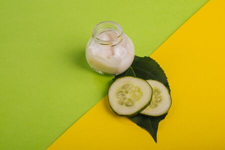 White cucumber cream on a yellow-green background.の写真素材